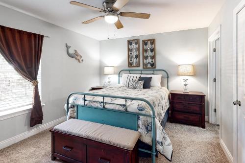 a bedroom with a bed and a ceiling fan at Turtles Nest in Dauphin Island