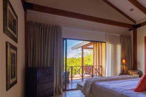 a bedroom with a bed and a balcony at Rancho Humo Estancia in Puerto Humo