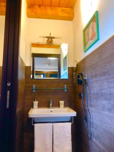 a bathroom with a sink and a mirror at Cuore Della Valle in Cefalù
