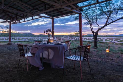 a table with chairs and a table with a table cloth at Rancho Humo Estancia in Puerto Humo