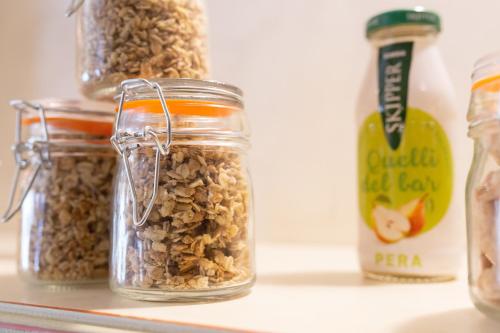 three jars of granola sitting on a shelf at Hotel Posta in Cecina