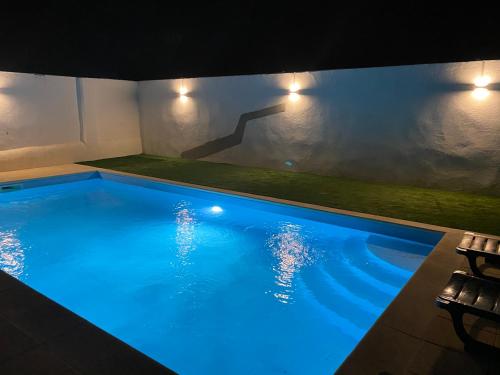 a large swimming pool with blue lighting in a house at Painel de Monsaraz in Reguengos de Monsaraz