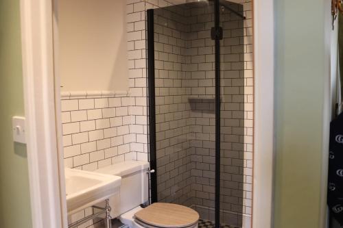 a bathroom with a toilet and a sink at Rafters at Riverside House Hotel in Bakewell
