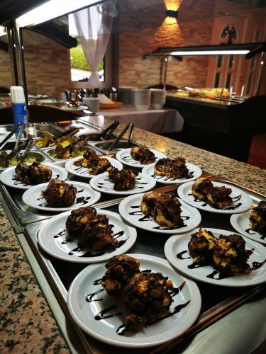 a group of plates of food on a table at Megálló Wellness Panzió in Pálháza