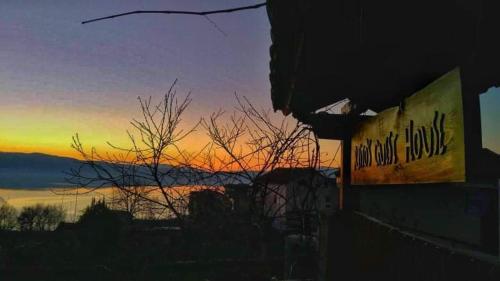 a sunset with a sign on the side of a building at Risto's Guest House in Ohrid