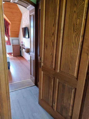 an open door to a room with a living room at Bodó Ház in Gyenesdiás
