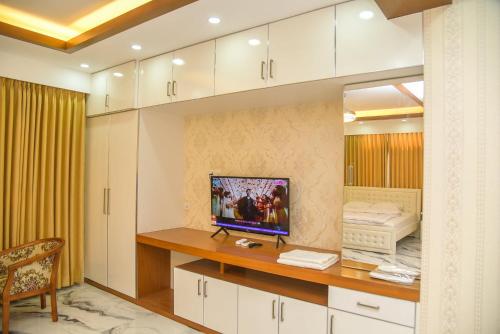 a room with a desk with a television on it at The Castle Inn in Dhaka