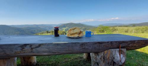 a table with a plate of bread and a bottle of beer at Вила Орцево Vila Ortsevo in Ortsevo