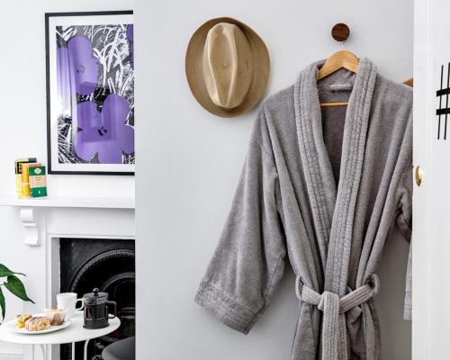 a towel hanging on a wall next to a fireplace at Townhouse Exeter in Exeter