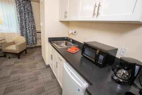 a kitchen with a sink and a microwave on a counter at Lakeshore Inn in Lake Oswego