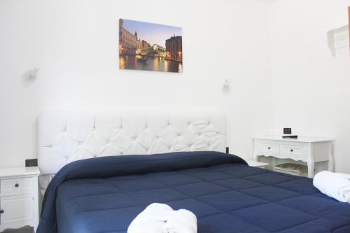 a bedroom with a large bed with a blue blanket at Hotel Marittima in Rimini