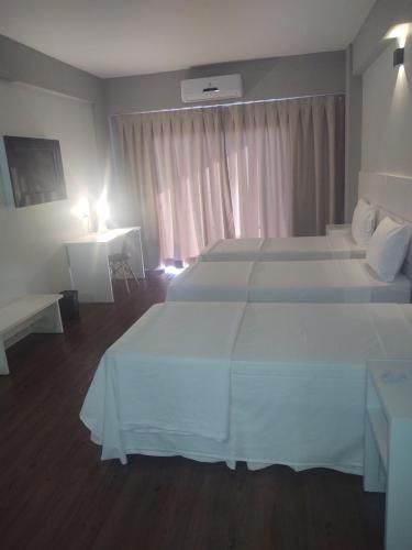 Ένα ή περισσότερα κρεβάτια σε δωμάτιο στο Hotel Quartzo