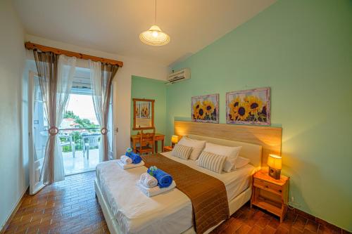 a bedroom with a large bed with towels on it at Apartment Zeus with private pool and sea view in Nisakion