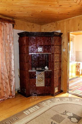 a large wooden cabinet in a room with a rug at Manor "U Bervinovy" in Yaremche