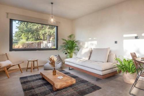 a living room with a couch and a table at forest view villas 2 in Lagoúdi Zía