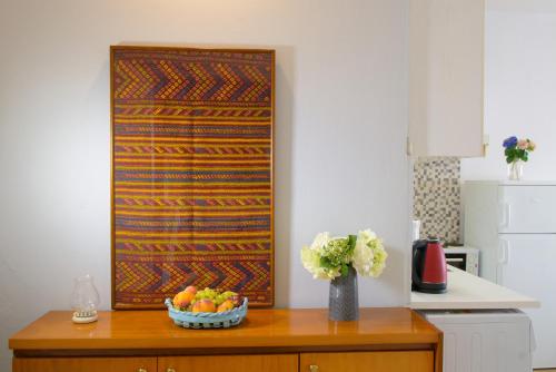 a kitchen with a table with a bowl of fruit at Bellevue Suites in Agios Nikolaos