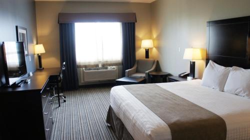 a hotel room with a bed and a window at Best Western PLUS Fort Saskatchewan Inn & Suites in Fort Saskatchewan