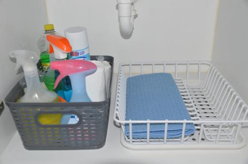 a basket with toothbrushes and other items in a sink at Cozy Stays Cayala Apartments 5 in Guatemala