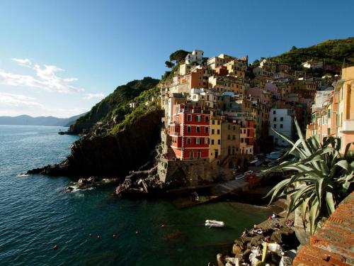a group of buildings on a hill next to the water at Alla Marina Affittacamere in Riomaggiore