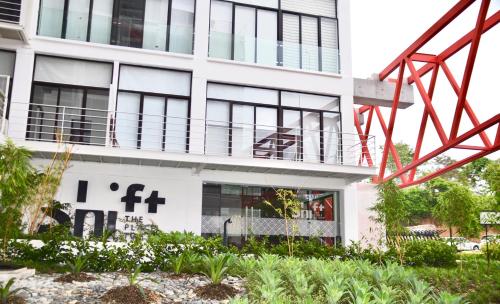 a building with a red metal object in front of it at Cozy Stays Cayala Apartments 5 in Guatemala
