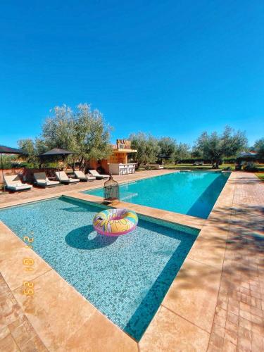 a swimming pool with a beach ball in the water at Villa Kristy in Marrakech