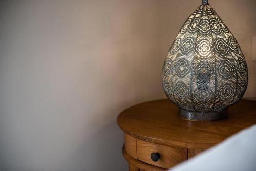 a vase sitting on top of a wooden table at Avra Apartments Kolymbari Harbour in Kolymvari