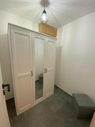 a room with a white cabinet and a light at Neurenovierte Ferienwohnung Xaver in Holzkirchen
