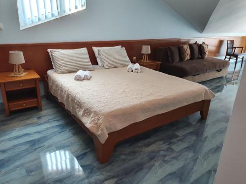 two stuffed animals on a bed in a room at Tazex Apartments in Herceg-Novi
