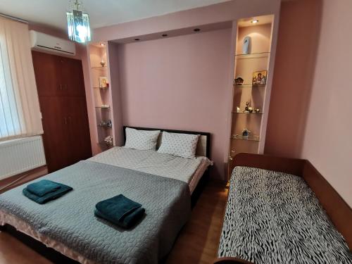 a bedroom with two beds with towels on them at Central Apartment Targovishte in Targovishte