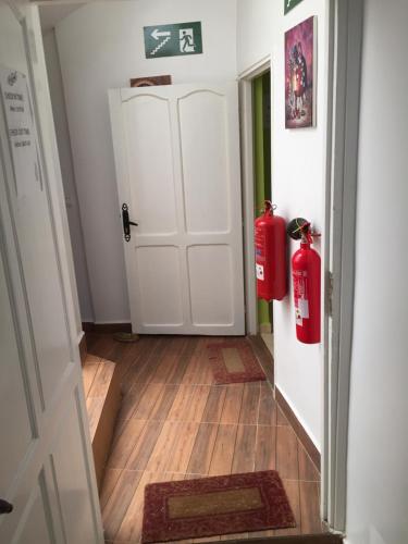a hallway with a door and two fire hydrants at Dar Surf in Taghazout