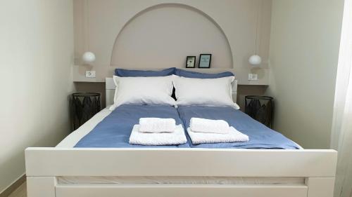a white bed with two towels on it at Lovely Private Flats FREE parking in Novi Sad