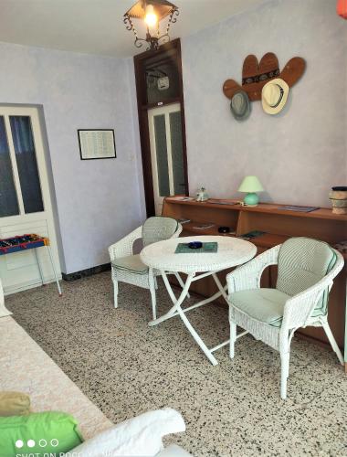 a living room with a table and chairs at Villa Radić in Makarska