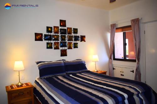 a bedroom with a blue and white striped bed at Marina Pinacate A-316 in Puerto Peñasco