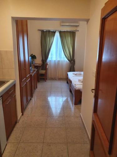 a hallway of a room with a bed and a table at Tazex Apartments in Herceg-Novi
