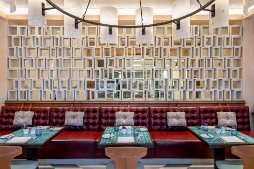 a restaurant with two tables and a wall of books at Viceroy Kopaonik Serbia in Kopaonik