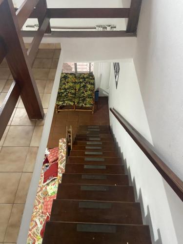 a staircase in a building with a bunch of blankets at Casa da Si Hostel in Ubatuba