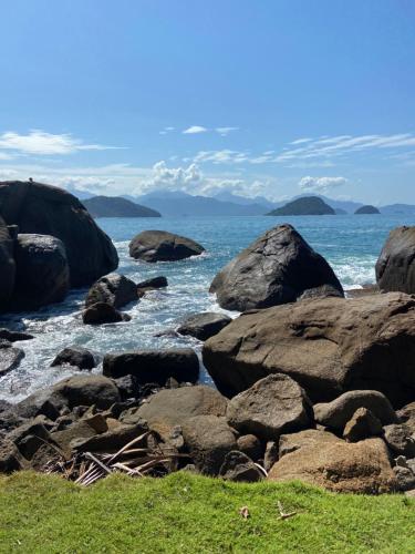 a group of rocks on the shore of the ocean at Casa da Si Hostel in Ubatuba