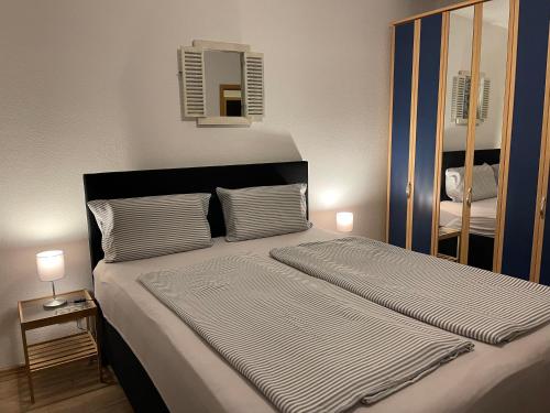 a bedroom with a large bed with a mirror at Ferienwohnung Geidel in der Altstadt Nordhausen in Nordhausen
