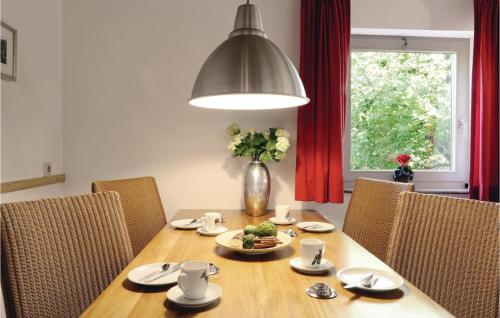 a dining room table with chairs and a vase with flowers at Ferienhaus 6 In Thalfang in Thalfang