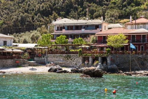 a house on the shore of a body of water at Kastro Studios in Damouchari