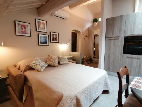 a bedroom with a white bed in a room at Magnolia Loft in Ferrara