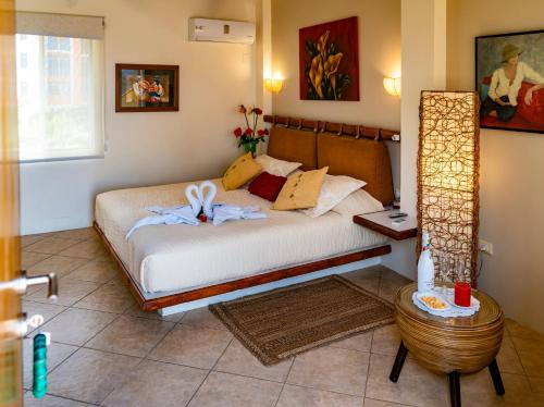 a bedroom with a bed with towels on it at Hotel Boutique Playa Canela Ecuador in Salinas