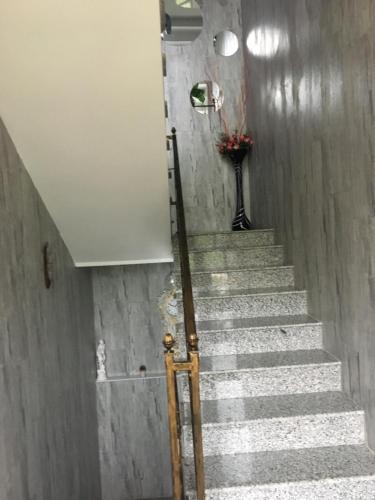 a set of stairs with a vase of flowers at hotel twins G&G in K'obulet'i