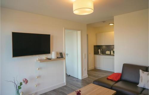 a living room with a couch and a flat screen tv at 1 Bedroom Cozy Apartment In Kappeln in Kappeln