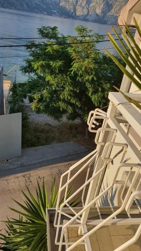 a couple of white chairs sitting on the beach at Viva House in Kotor