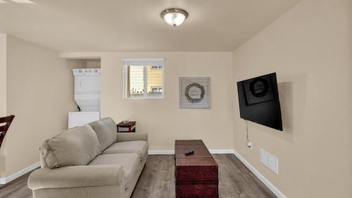 a living room with a couch and a table at Your Nest Away from Home in Colorado Springs