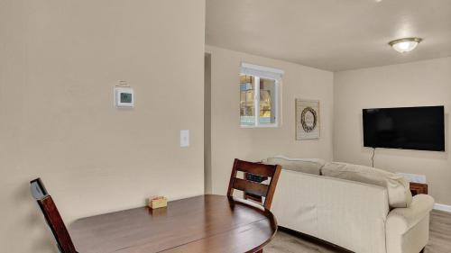 a living room with a couch and a table at Your Nest Away from Home in Colorado Springs
