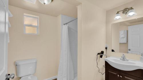 a bathroom with a shower and a toilet and a sink at Your Nest Away from Home in Colorado Springs