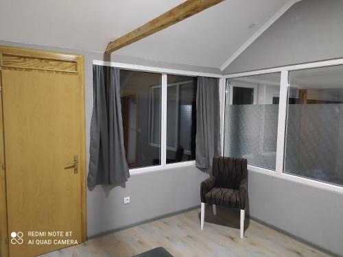 a room with a chair and a window at Lenilenii Bungalows in Jajce
