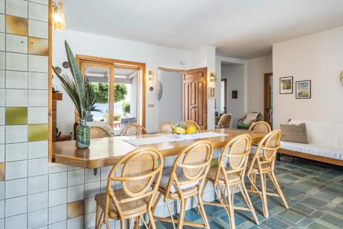 a kitchen and dining room with a table and chairs at Amazing View Beach Villa in Santa Maria
